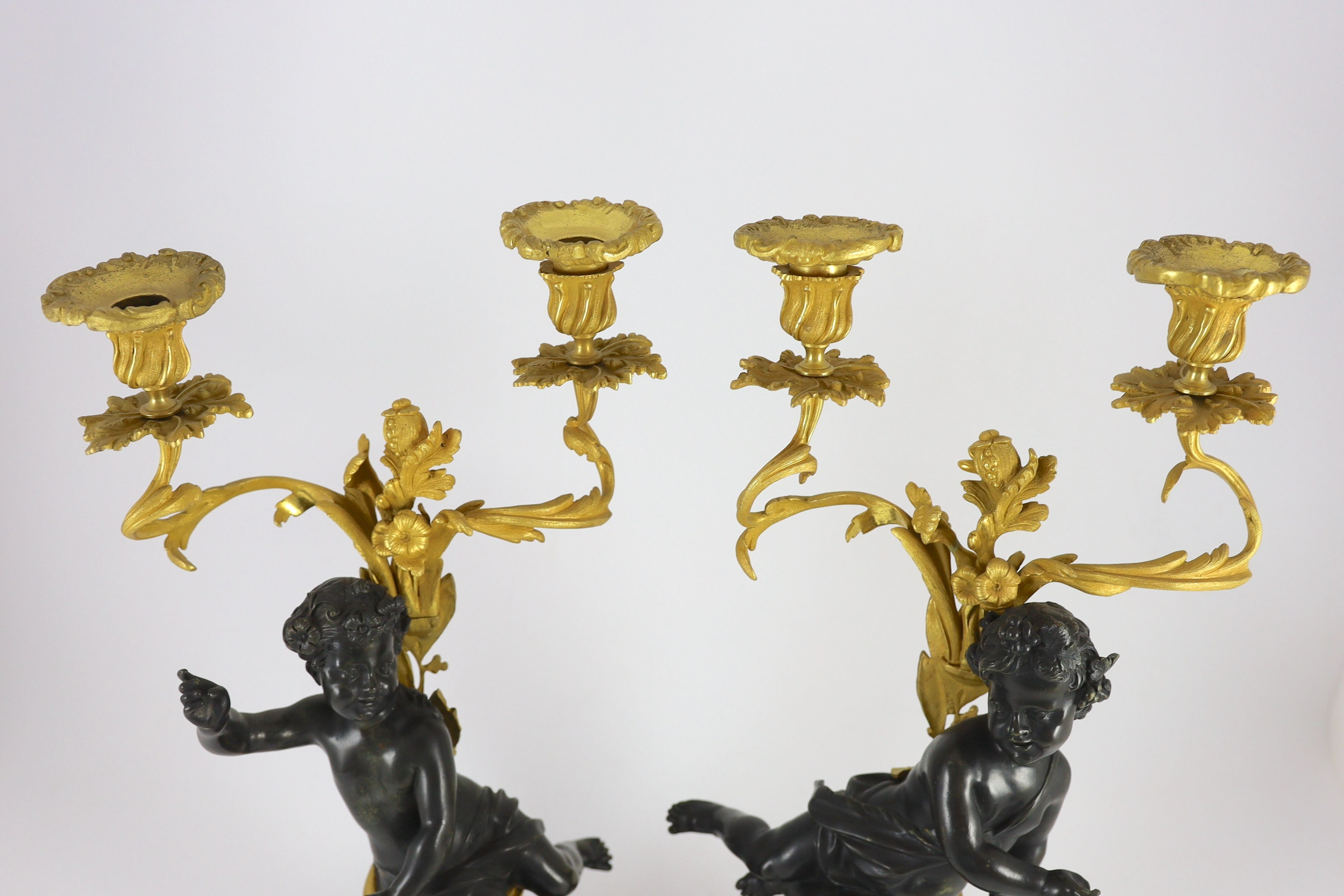 A pair of Louis XVI style bronze and ormolu two light candelabra, 22cm wide, 51cm high